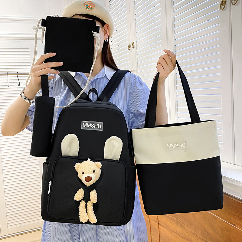 A cute cartoon bear backpack set of four pieces, a large-capacity hand-held after-school bag for primary school students, a casual and versatile trendy backpack Application Scenario