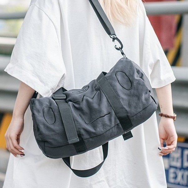 A new 2025 fashionable single-shoulder bag with a smiling face pattern for both men and women, a hand-held crossbody bag with a letter zipper and a casual cylindrical bag full figure