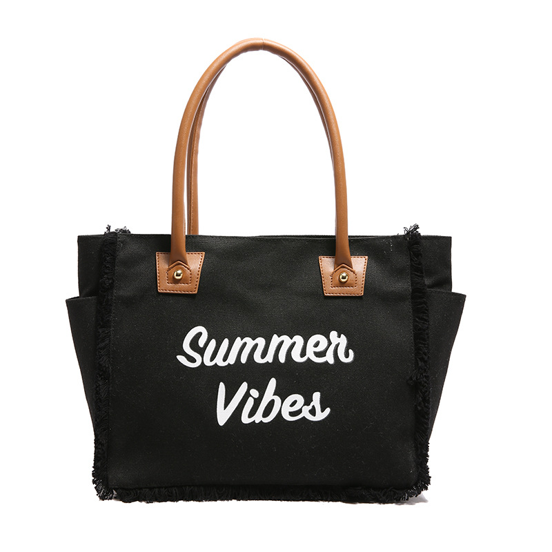 The 2025 new Korean-style letter-fringed canvas bag for women, a large-capacity, simple commuting student single-shoulder tote bag Item Picture