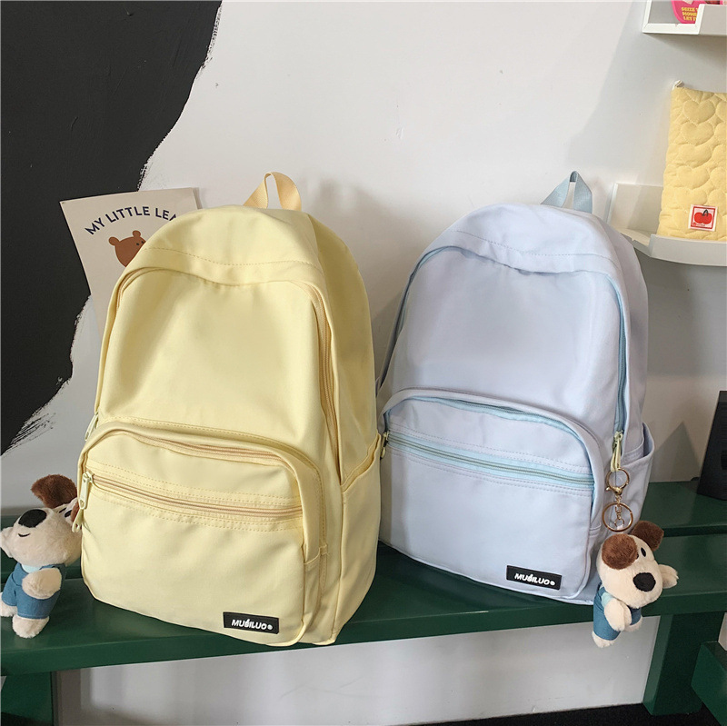 The new Korean-style casual backpack is a fresh and sweet schoolbag for high school students' classes and a fashionable solid-color travel backpack for girls full figure