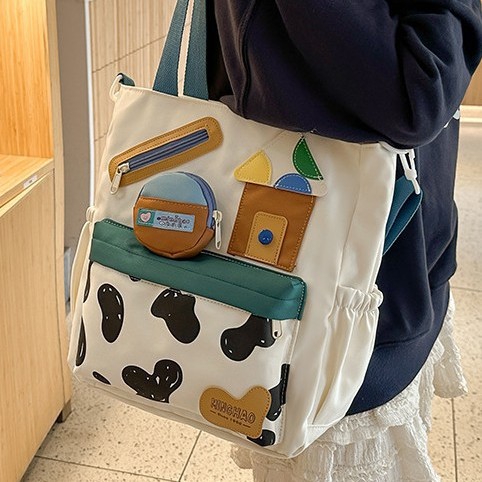 The new autumn 2024 collection features a cute single-shoulder crossbody bag with cow print, a student handbag, and a fun children's tutorial bag with a large capacity details Picture