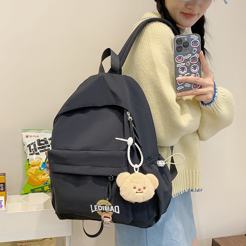This is a new 2024 high school backpack for female college students with a high level of appearance, featuring a simple solid color and a fresh look details Picture