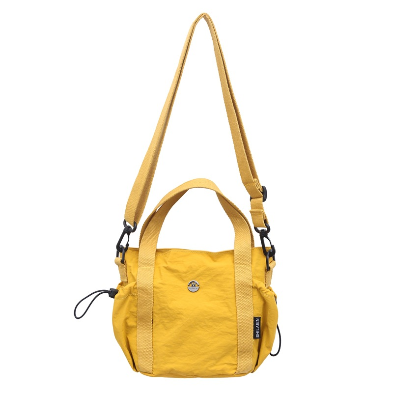 A new casual and fashionable Korean-style hand-held nylon bucket bag for men and women, a light, simple and versatile crossbody bag Item Picture