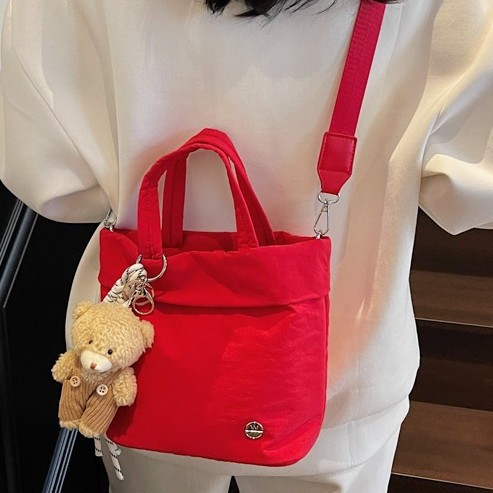 A new solid-color sporty and fashionable handbag from a trendy cartoon style, simple and water-resistant, casual and lightweight single-shoulder crossbody bag full figure