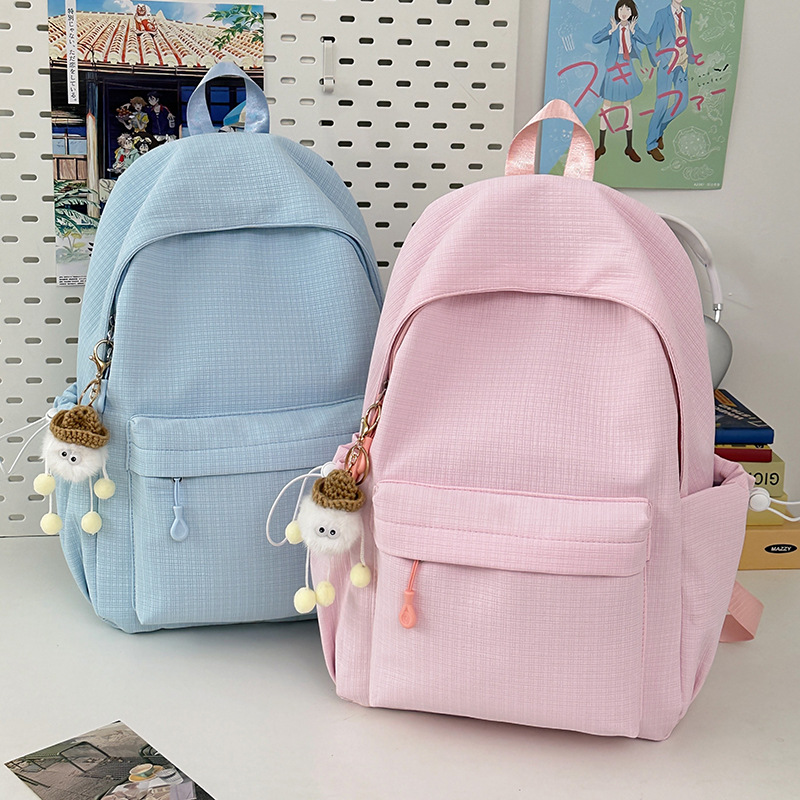 A new solid-color, simple and versatile, lightweight nylon backpack with a high aesthetic level. It is a schoolbag for junior high school, senior high school and college students full figure