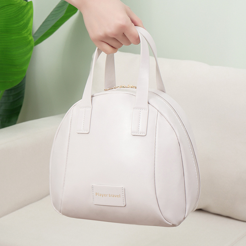 2024 New high-appearance-level shell makeup bag, ins large-capacity portable hand-held skin care and toiletries storage bag Application Scenario