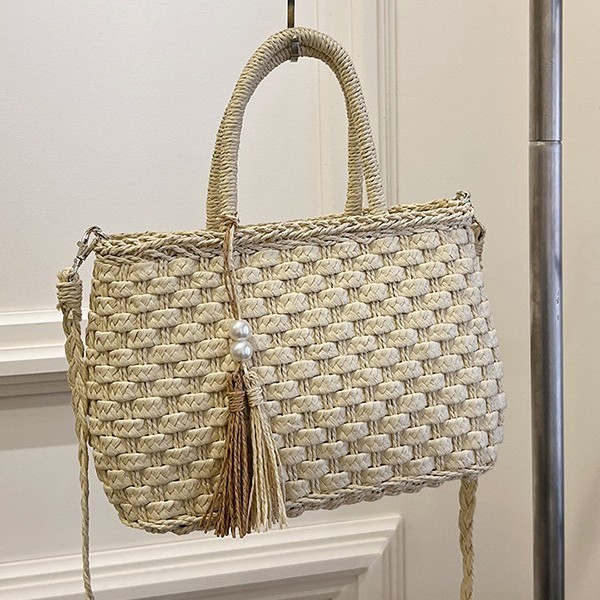 New summer straw woven bag with ethnic style, casual fringed and hollowed-out hand-held bag for women details Picture