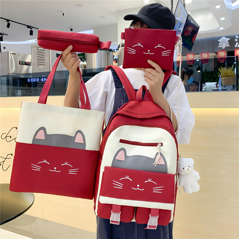 A new Korean-style schoolbag for girls, featuring cute cartoon cats, is a four-piece backpack set for grades three to six full figure