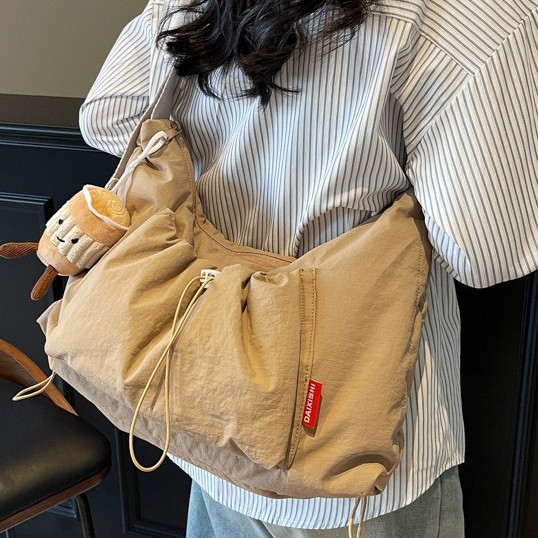 A new solid-color, girlish, large-capacity, sporty single-shoulder bag with a pleated drawstring design and a casual crossbody bag Application Scenario
