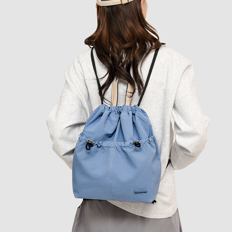 A new 2024 fashionable student backpack for women, a casual Korean-style backpack with drawstring pockets, and a travel bag details Picture