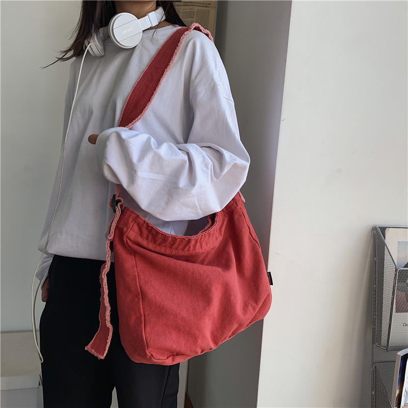 Washed canvas bag with fringed and aged edges, artistic single-shoulder bag, student class backpack, laid-back and simple cloth bag, crossbody bag full figure