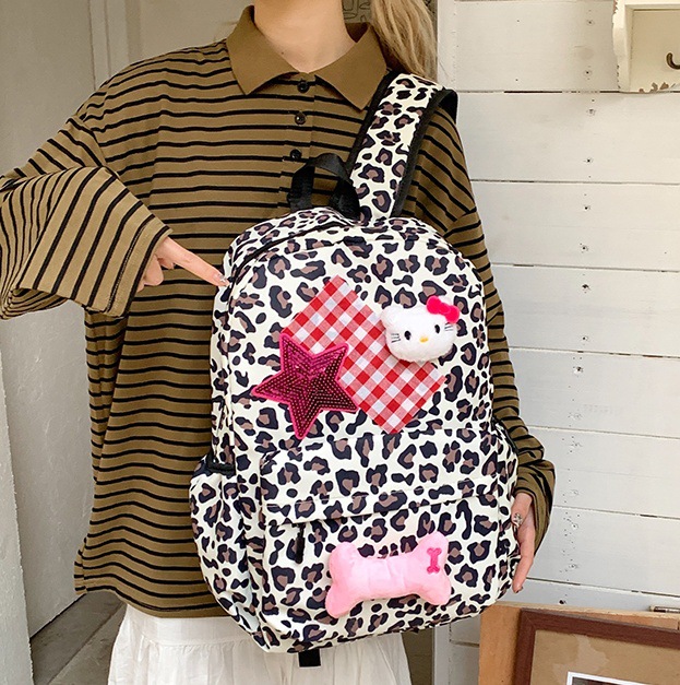 A cute Korean-style schoolbag with a niche design, featuring cartoon leopard print and a large capacity backpack for high school and college students full figure