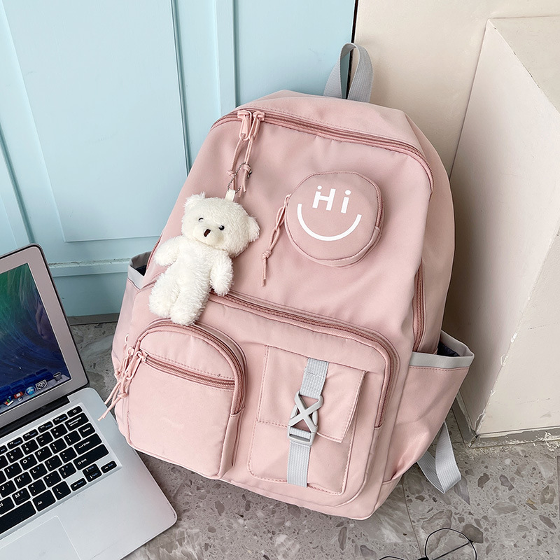 Smiley face fashionable backpack, schoolbag for primary and middle school students, toy pendant bag, cute campus leisure, burden relief for girls full figure