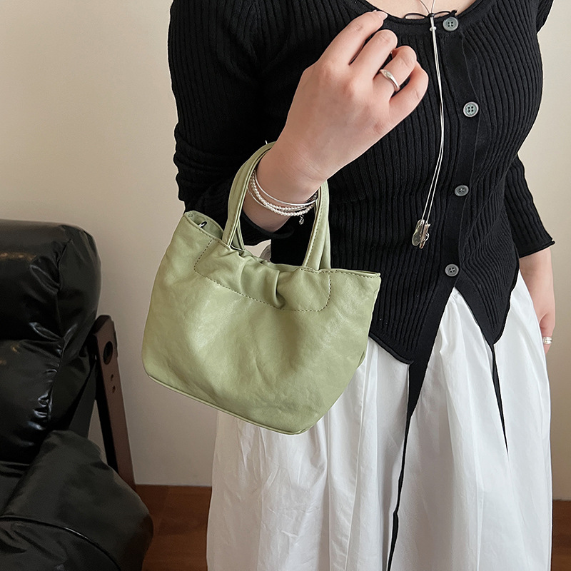 The 2025 new niche design solid-color hand-held bucket bag exudes a sense of sophistication, simplicity and fashion, and is a single-shoulder crossbody bag for commuting details Picture