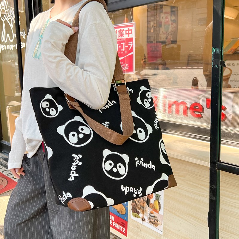 A niche new 2025 Panda hand-held canvas bag for girls to attend classes, a crossbody bag for college students, and a single-shoulder bag for commuting and going out details Picture
