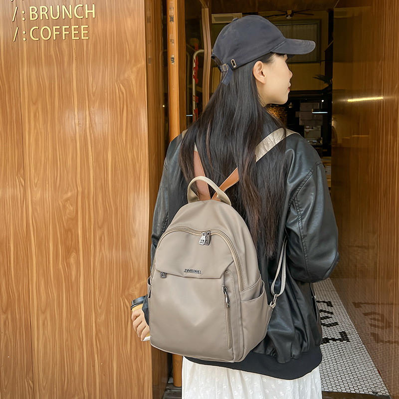 This backpack is lightweight and large-capacity for women's commuting and travel. It's versatile and fashionable for moms when they go out. It's also a schoolbag for college students details Picture