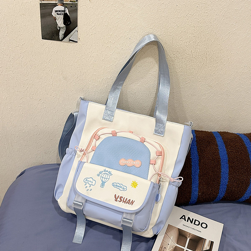 The fresh Korean-style color-blocking tutorial bag for spring and summer is a new style that catches the eye. It has a large capacity single-shoulder handbag and is a student's crossbody bag for class Application Scenario