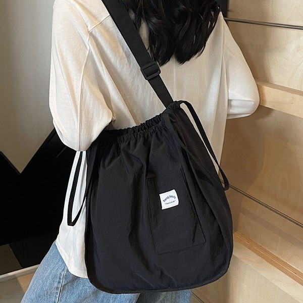 The 2025 new lightweight handbag is a small and exquisite cloth bag with a solid color and simple drawstring. It is a student portable single-shoulder bag Application Scenario