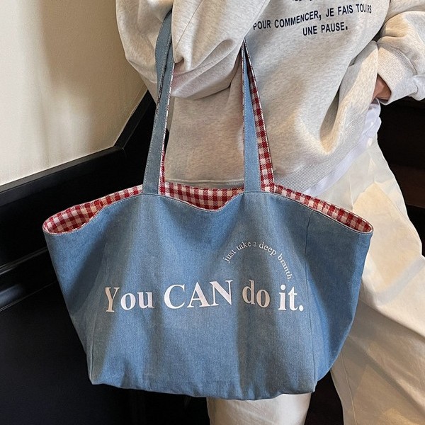 This canvas bag features a niche design with an ins high-end feel. It's a large-capacity commuter single-shoulder bag with Korean-style striped shopping bags on both sides Application Scenario