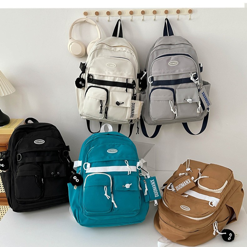 Japanese-style simple solid-color casual backpack, high appearance level, junior high school student schoolbag, large capacity, versatile, workwear-style backpack full figure