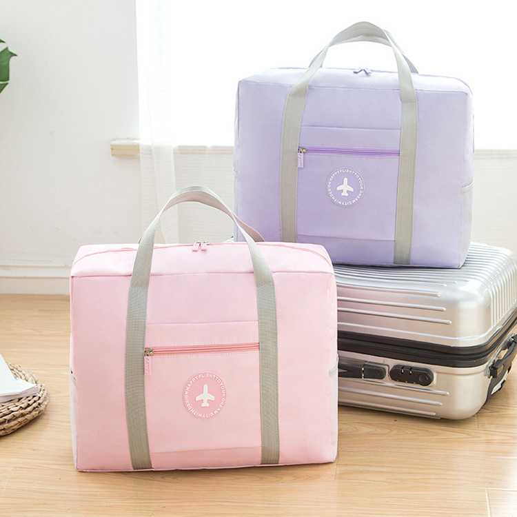A large-capacity Japanese-style travel solid-color, fresh and simple round-label handle bag, folding travel clothing storage bag, and cotton quilt bag full figure