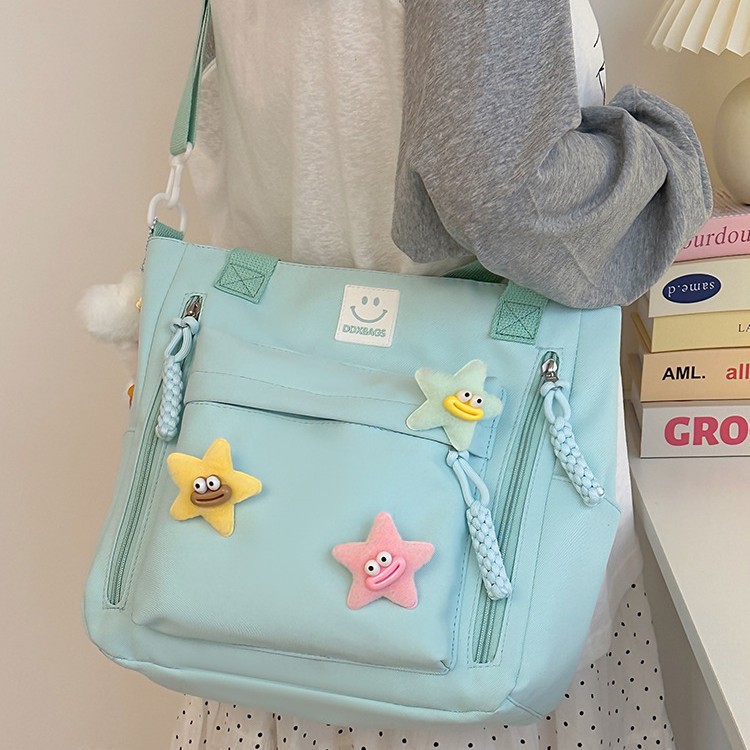 A versatile and casual fabric bag with a star-shaped design, lightweight and waterproof single-shoulder bag, and a crossbody bag for classes and shopping Application Scenario