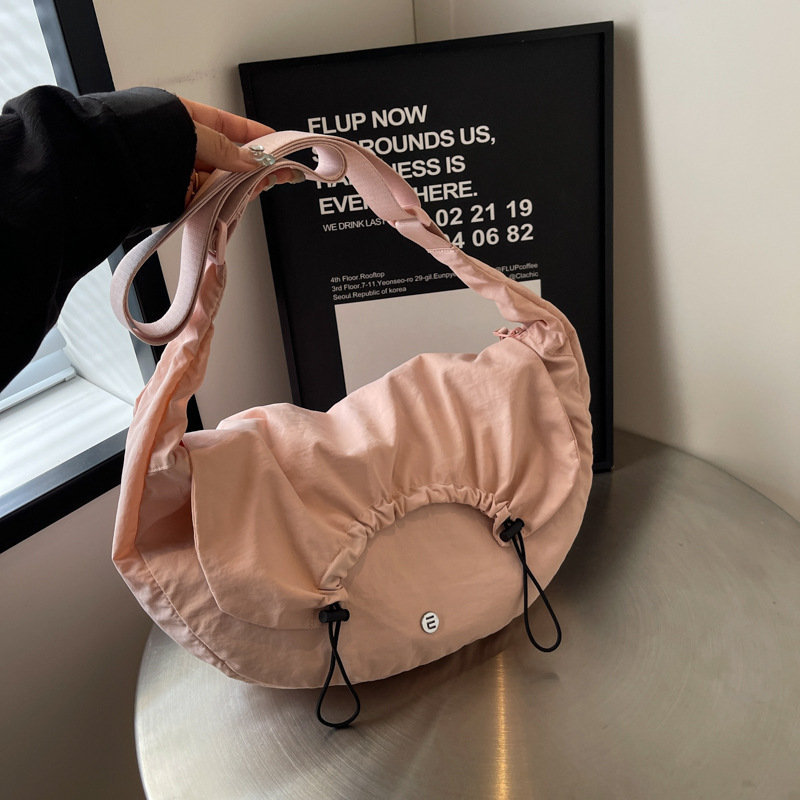 A new cross-border lightweight pleated crossbody bag, a fashionable commuting student hand-held fabric bag with a drawstring at the top, a Japanese-style single-shoulder bag full figure