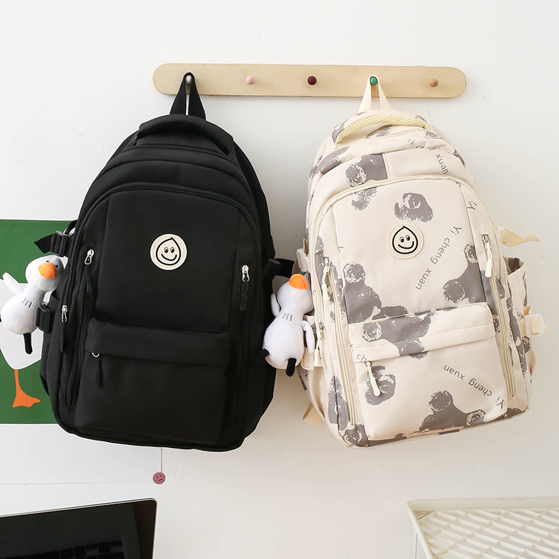 2025 New style of smiling face, large capacity, versatile, fashionable and casual college student backpack with prints for junior and senior high school students details Picture