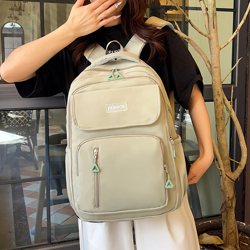 Wholesale solid color, simple and large-capacity campus-style backpacks for college and junior high school students to reduce the burden of backpacks full figure
