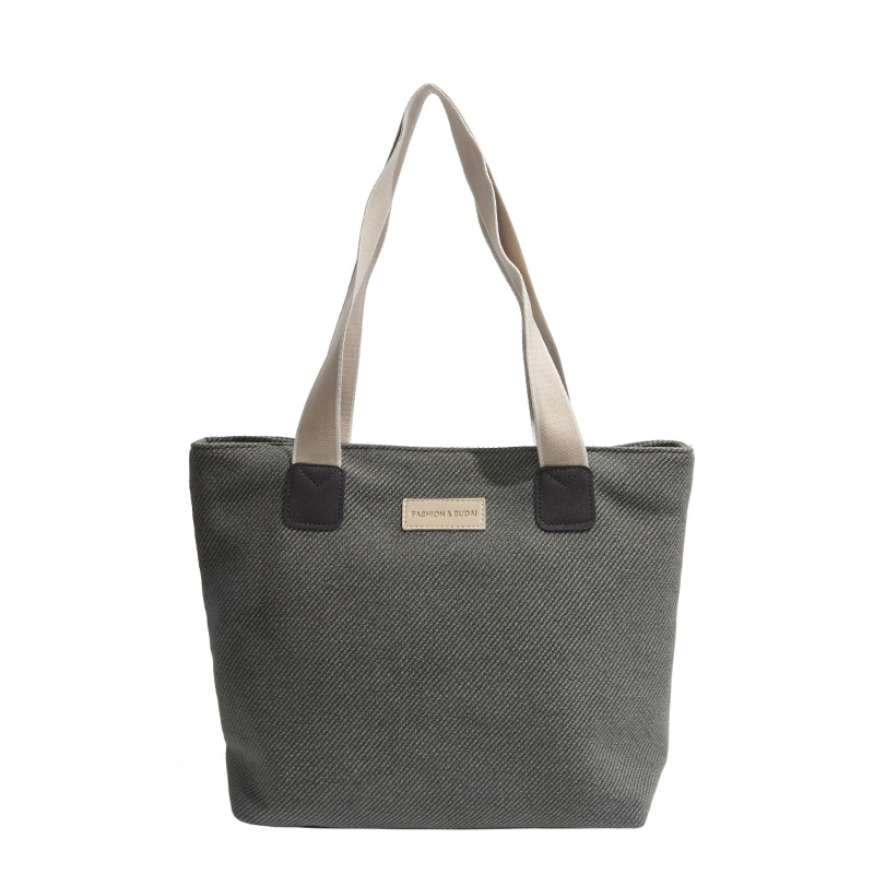 The new solid-color handbag for the autumn and winter of 2024 is a versatile and casual large-capacity, laid-back tote bag for girls to take classes on one shoulder Item Picture