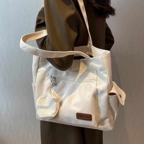 A large-capacity canvas bag for women, a new Spring/Summer 2025 Japanese-style casual Instagram commuting tote bag for college students Application Scenario