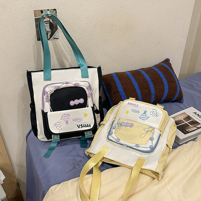 The fresh Korean-style color-blocking tutorial bag for spring and summer is a new style that catches the eye. It has a large capacity single-shoulder handbag and is a student's crossbody bag for class details Picture