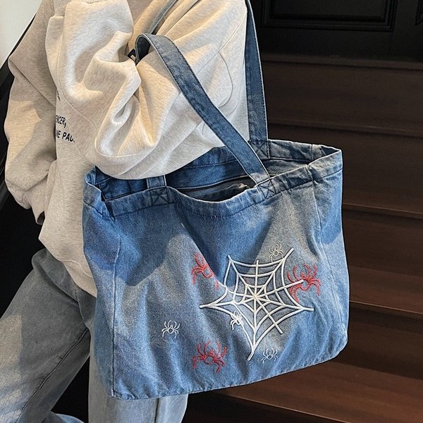 A versatile Instagram Korean denim tote bag for women 2025, featuring a large capacity single-shoulder bag with embroidered design for commuting full figure