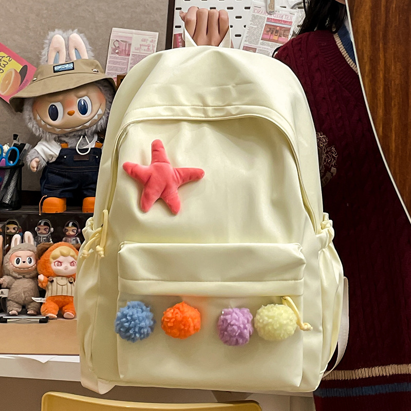 Minimalist style backpack, light and casual commuting style, trendy minimalist backpack, cute pom-pom girl style backpack details Picture