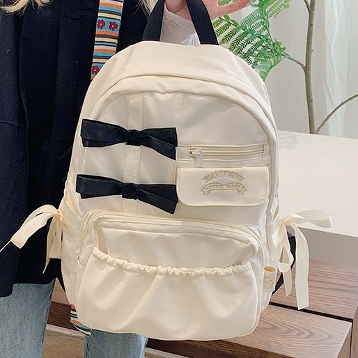 The new Japanese ins2024 backpack for girls with a high level of appearance, a bow backpack, and a cute cream-style backpack for students full figure
