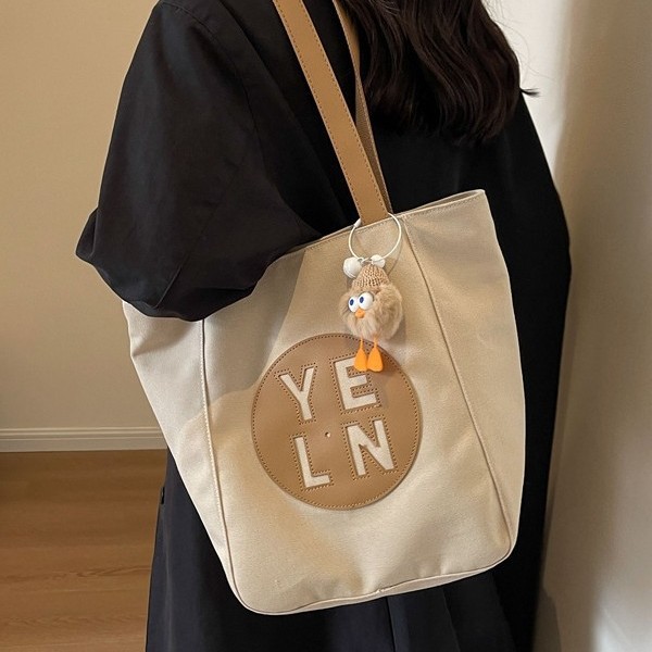 Large-capacity tote bag for women 2025, fashionable, casual and versatile canvas bag, niche hollowed-out high-end student single-shoulder bag full figure