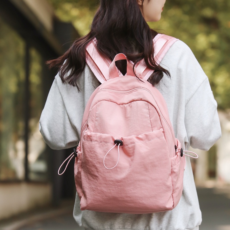 A new pink large-capacity, high-end casual commuting bag with a simple nylon travel backpack in the style of a cross-border college details Picture