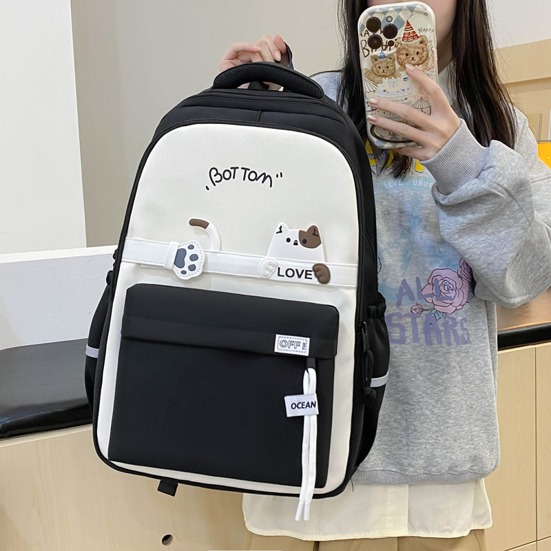 The new nylon schoolbag has a high appearance level. It is a multi-layered casual backpack with cute cats for middle school students full figure