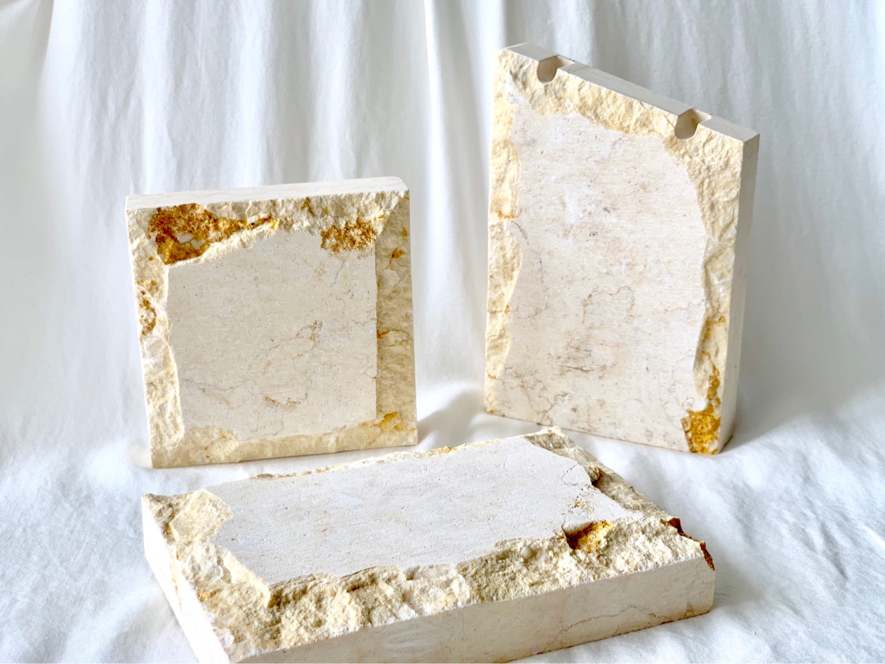 A natural stone and rock jewelry necklace display with a beige marble base for taking photos. Exhibition photo props details Picture