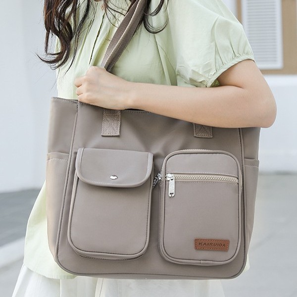 This is a new, simple and fashionable handbag for women. It is a large-capacity, trendy and high-quality nylon multi-layered single-shoulder bag full figure