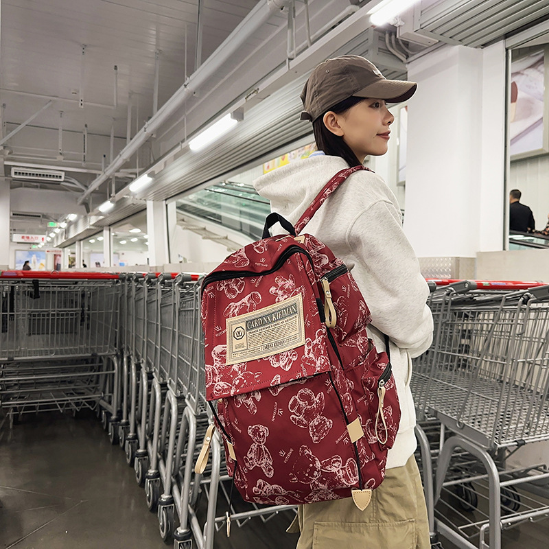 A simple printed bear large-capacity backpack for junior high school girls, a new trendy couple computer bag for college students details Picture
