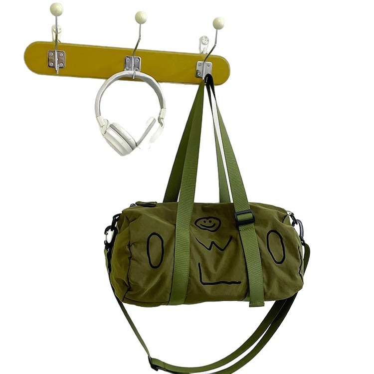A new 2025 fashionable single-shoulder bag with a smiling face pattern for both men and women, a hand-held crossbody bag with a letter zipper and a casual cylindrical bag Item Picture
