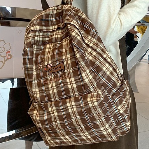 The new large-capacity backpack with a checkered pattern and a fresh and cute school style, the lightweight backpack, and the new forest-themed bag for autumn and winter details Picture