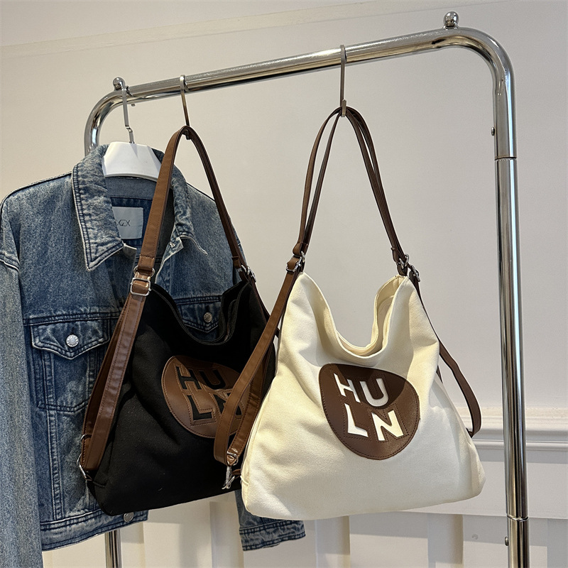 Women's large-capacity 2024 new letter-shaped canvas bag, fashionable single-shoulder bag, versatile commuter college student tote bag Application Scenario