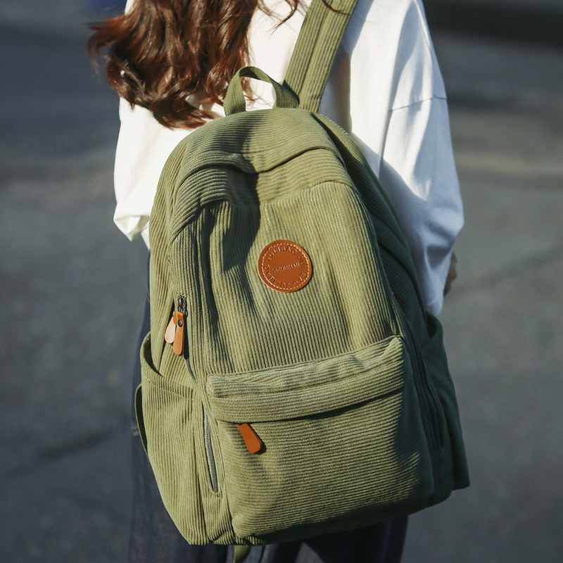 The new corduroy backpack for autumn and winter 2024 is a solid color versatile large-capacity backpack suitable for both men and women full figure