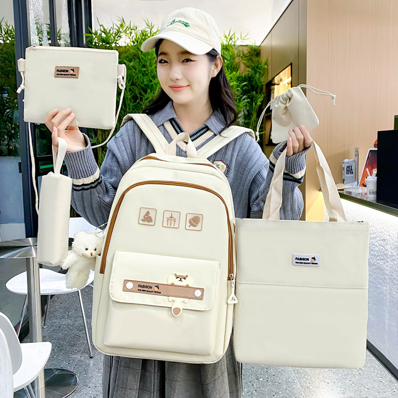 Cross-border spot wholesale of simple and versatile solid-color student schoolbags, large-capacity casual backpacks for women, five-piece sets of backpacks full figure