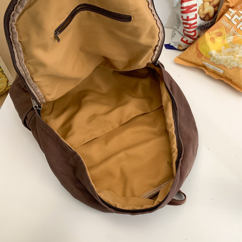 Retro feng shui washed canvas schoolbag for girls, junior high school, senior high school and college students, simple solid-color backpack, versatile travel backpack for men Application Scenario