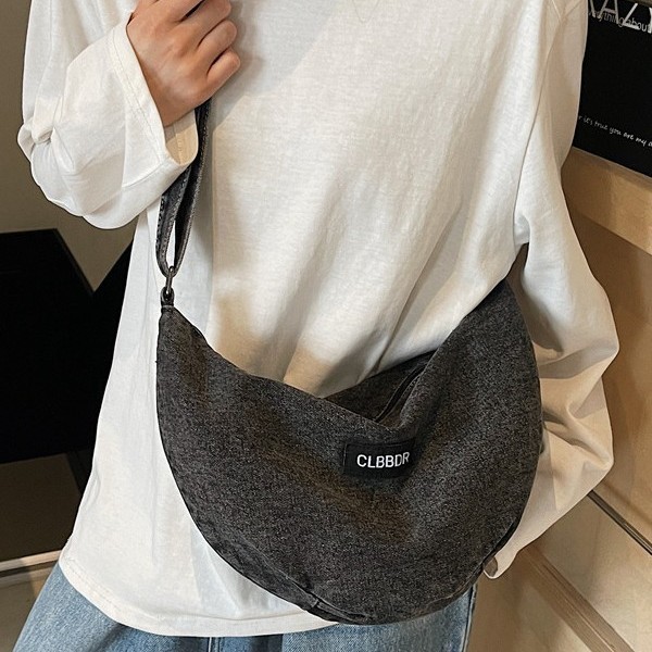 A new, fashionable and trendy single-shoulder crossbody bag with a solid color soft surface and large capacity, featuring a denim design full figure