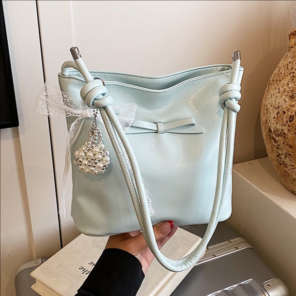 Korean style fashion niche bow hand-held bucket bag for women 2025 new summer, high-end and versatile single-shoulder underarm bag full figure