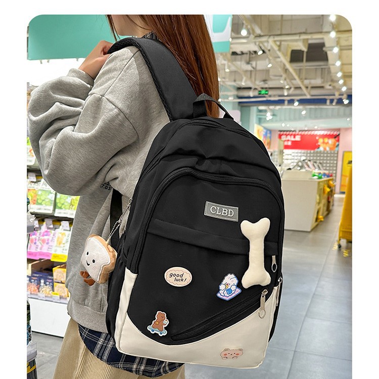 The 2025 new model of large-capacity, lighter-load macaron-colored backpack for students is a cute patchwork backpack for primary school students full figure